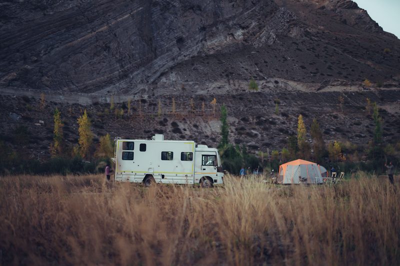 Caravan camping beneath high Himalayan peaks in Spiti