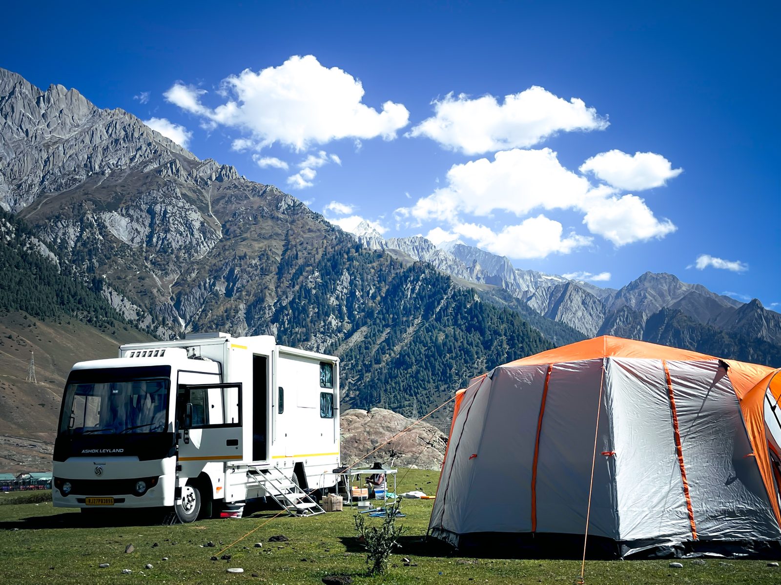 Caravan with tent and scenic backdrop